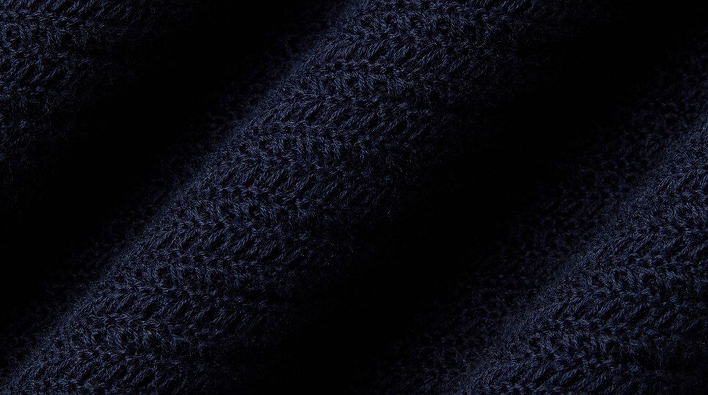 Composition abstraite chaotique de textiles en collision : maille laine grise, tissu synthétique rouge brillant et imprimé floral multicolore créant un ensemble visuellement discordant
